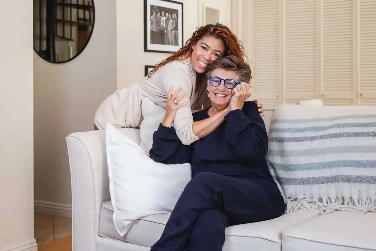 Elderly woman being hugged