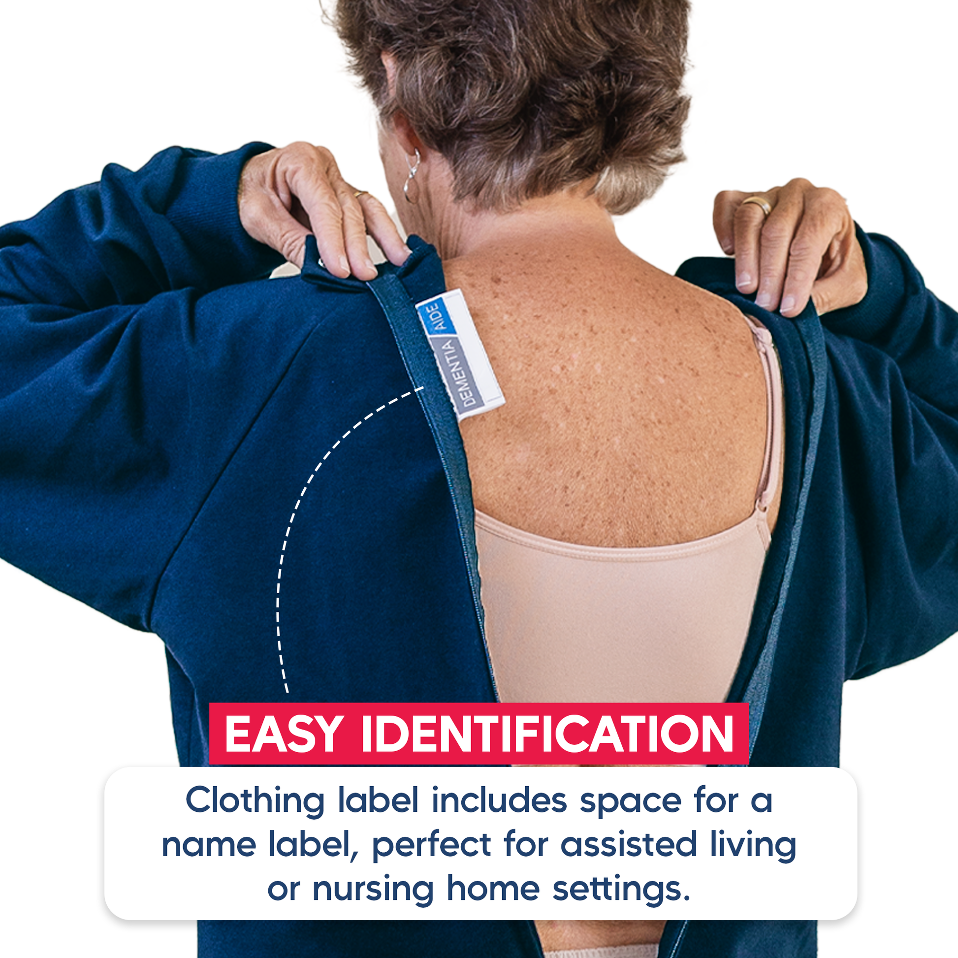 Person wearing a blue dementia jumpsuit with an easy identification label on the back, suitable for assisted living or nursing home settings.