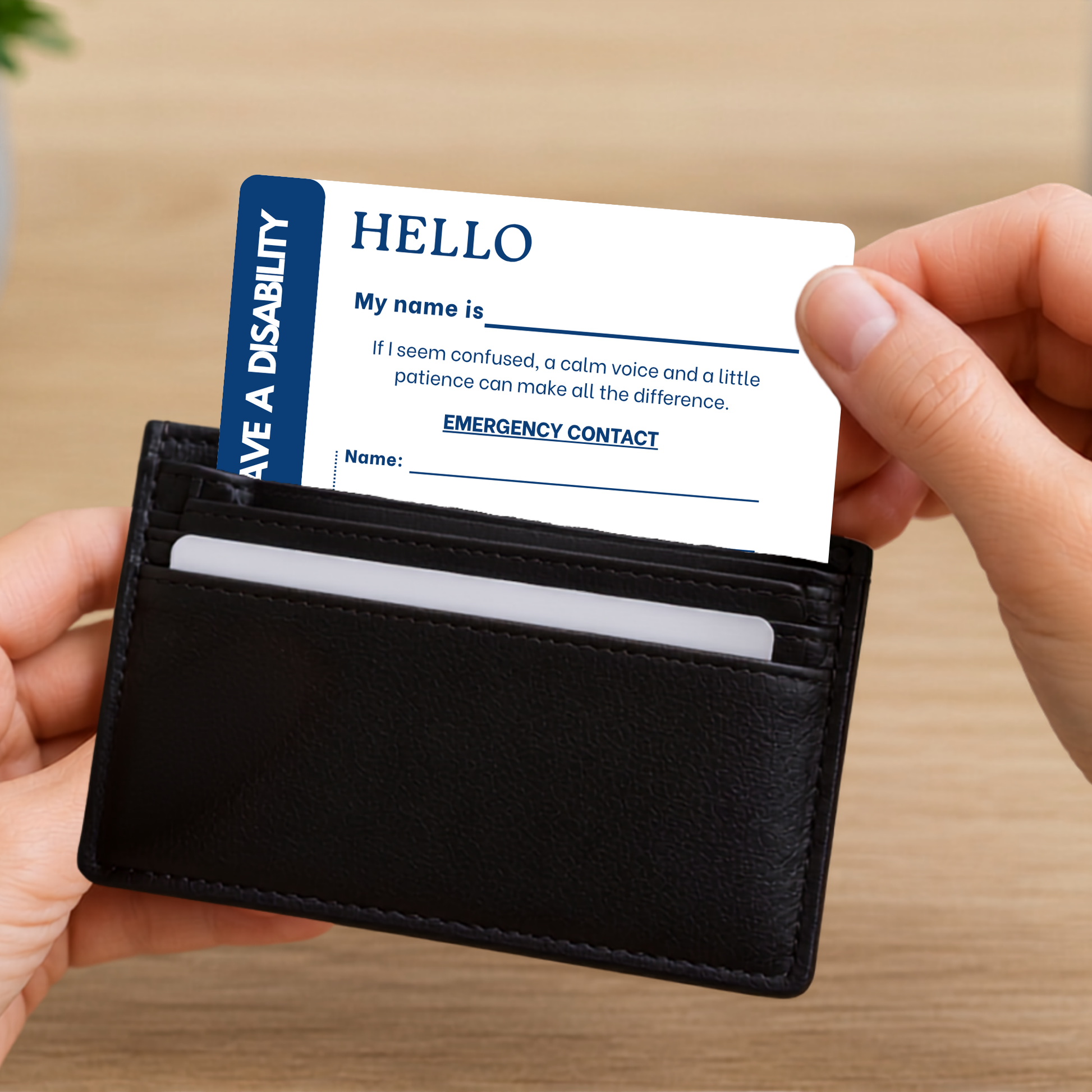 Person holding a black wallet with a disability awareness card inside.